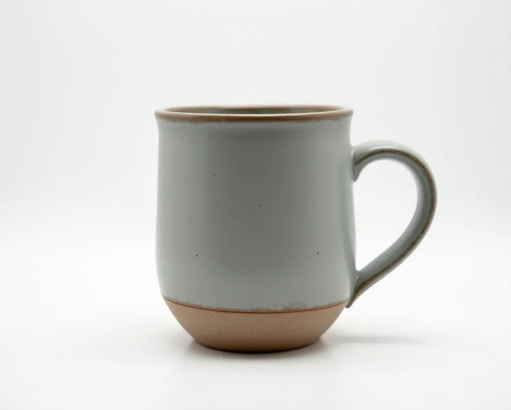 Handcrafted weighted ceramic mug with matte gray glaze studio shot